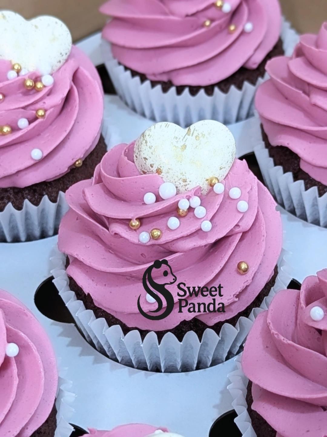 Chocolate cupcakes with pink textured buttercream, white pearl and gold bead decoration, and white heart toppers