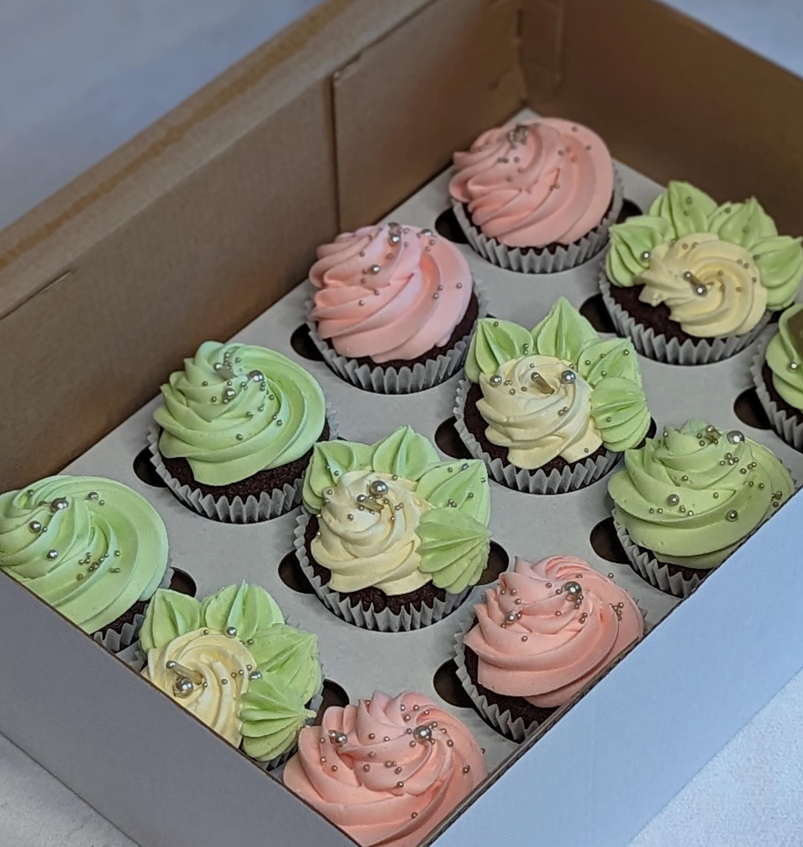 Nine cupcakes with textured buttercream frosting in pale green