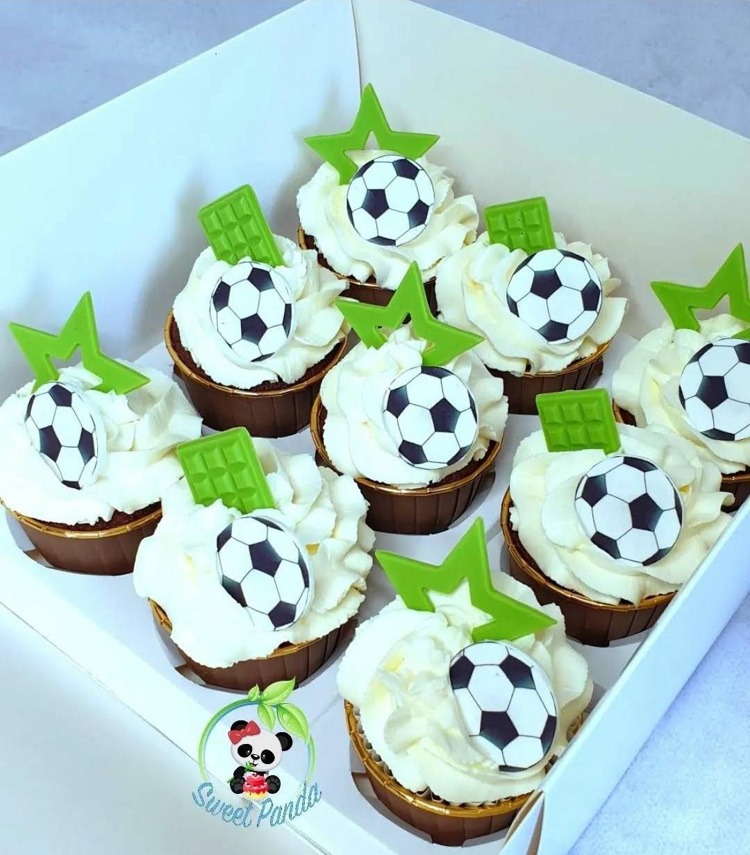 Ten chocolate cupcakes with white buttercream, decorated with football toppers and bright green star and square toppers