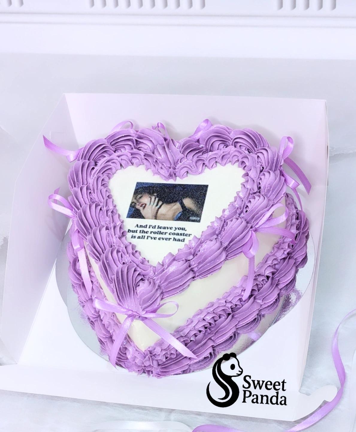 Heart-shaped celebration cake with lavender textured buttercream piping, white centre panel with printed photo and quote