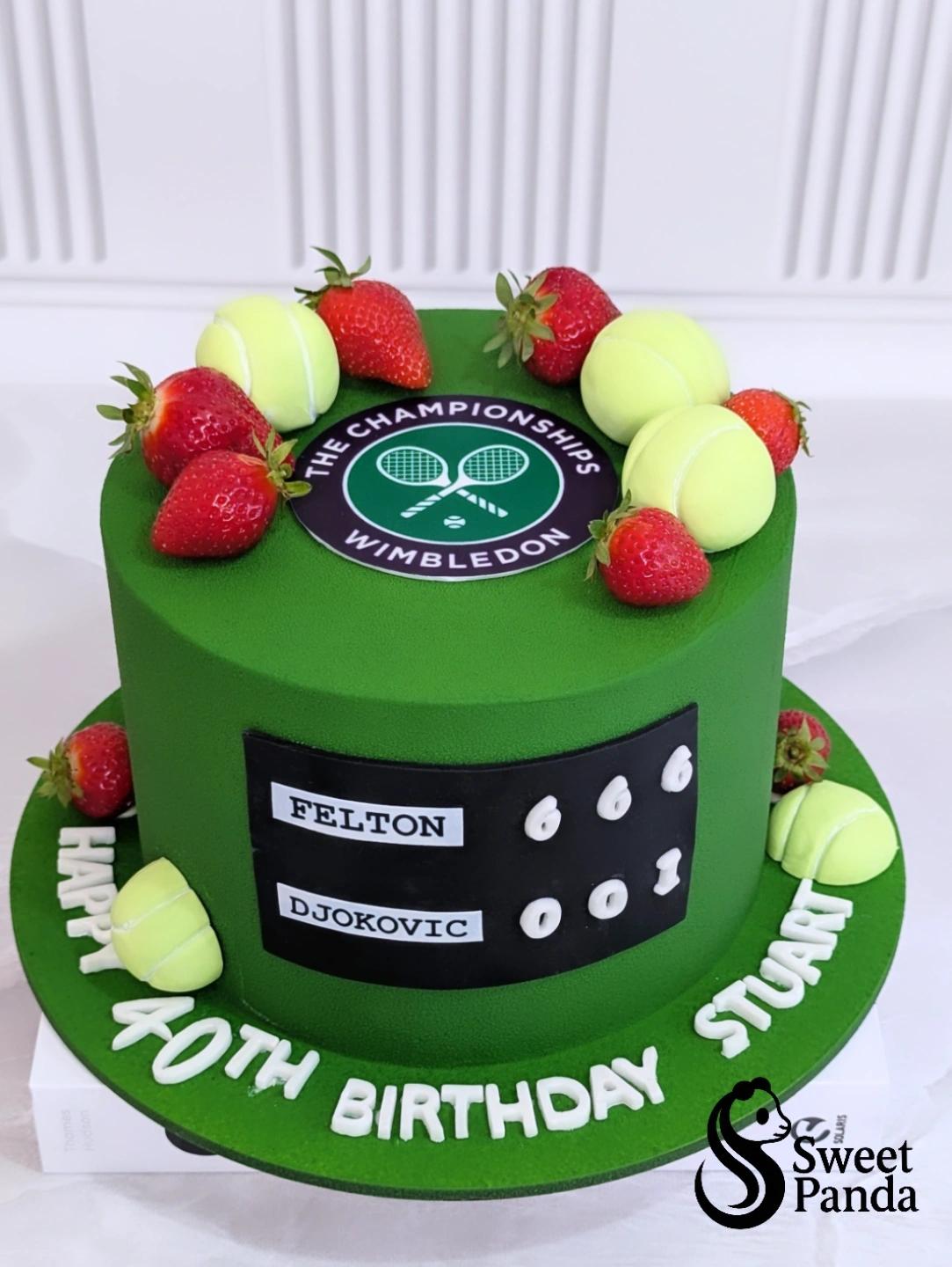 Two-tier green fondant cake with Wimbledon Championships logo, fresh strawberries, yellow tennis ball macarons