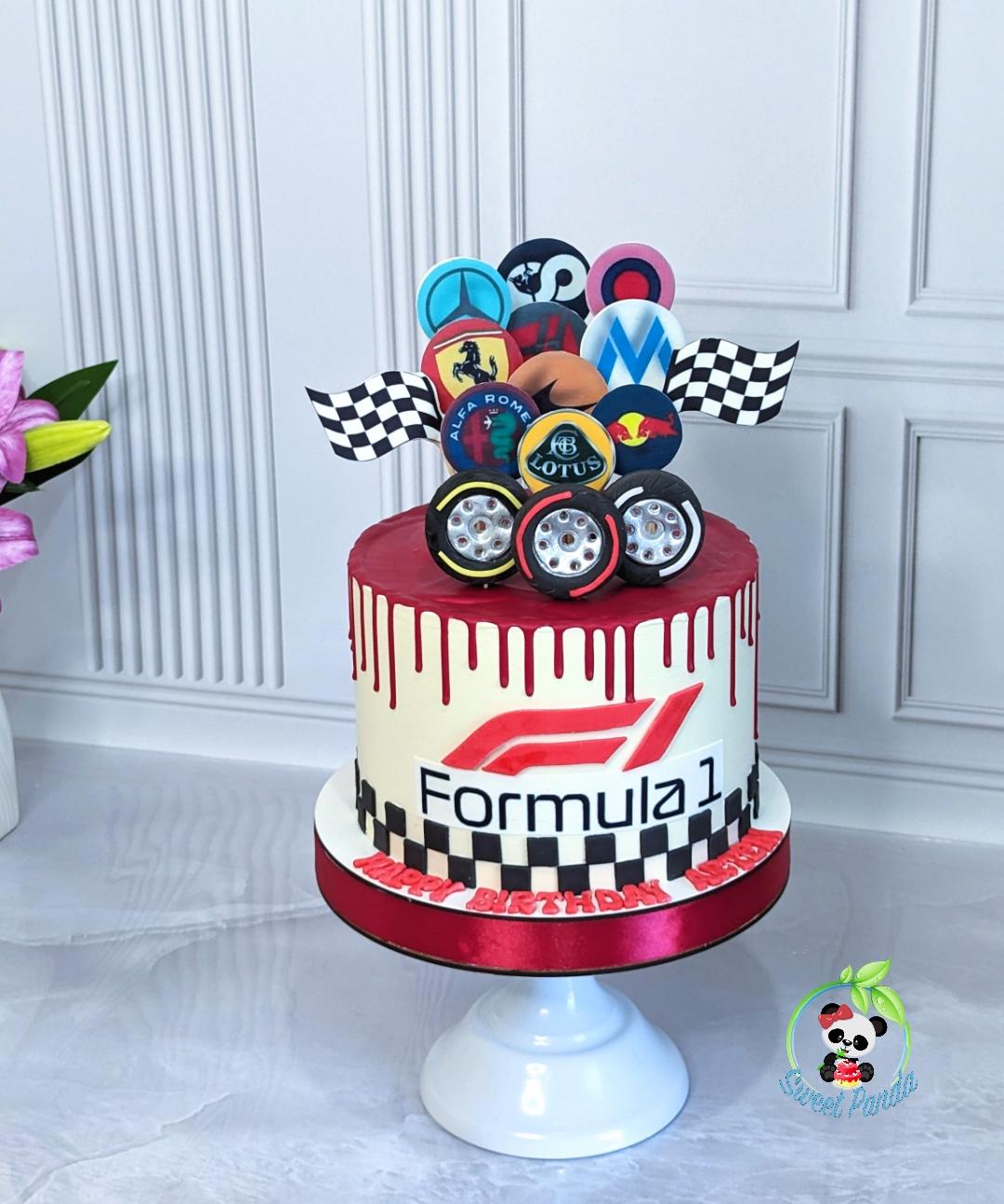 Formula 1 themed celebration cake with red drip top, cream base, black and white checkered stripe